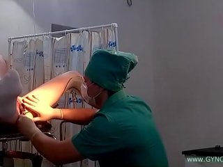 A young young babe in white socks on a gynecological chair